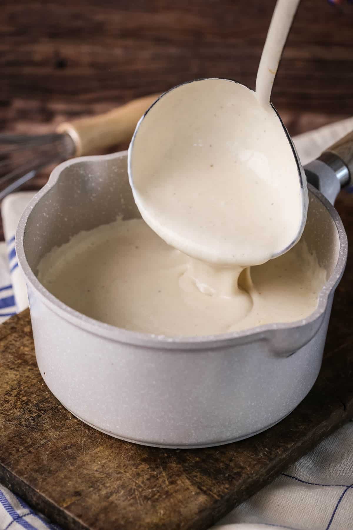 Smooth and creamy Gluten-Free Bechamel Sauce in a saucepan.