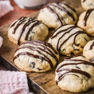 Easter Cookies packed with marzipan, currants, spice and chocolate resting on a wooden board.