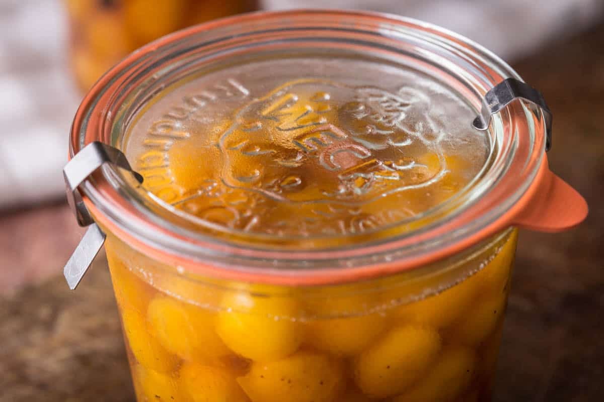 Pickled Mirabelles in a clip top jar.