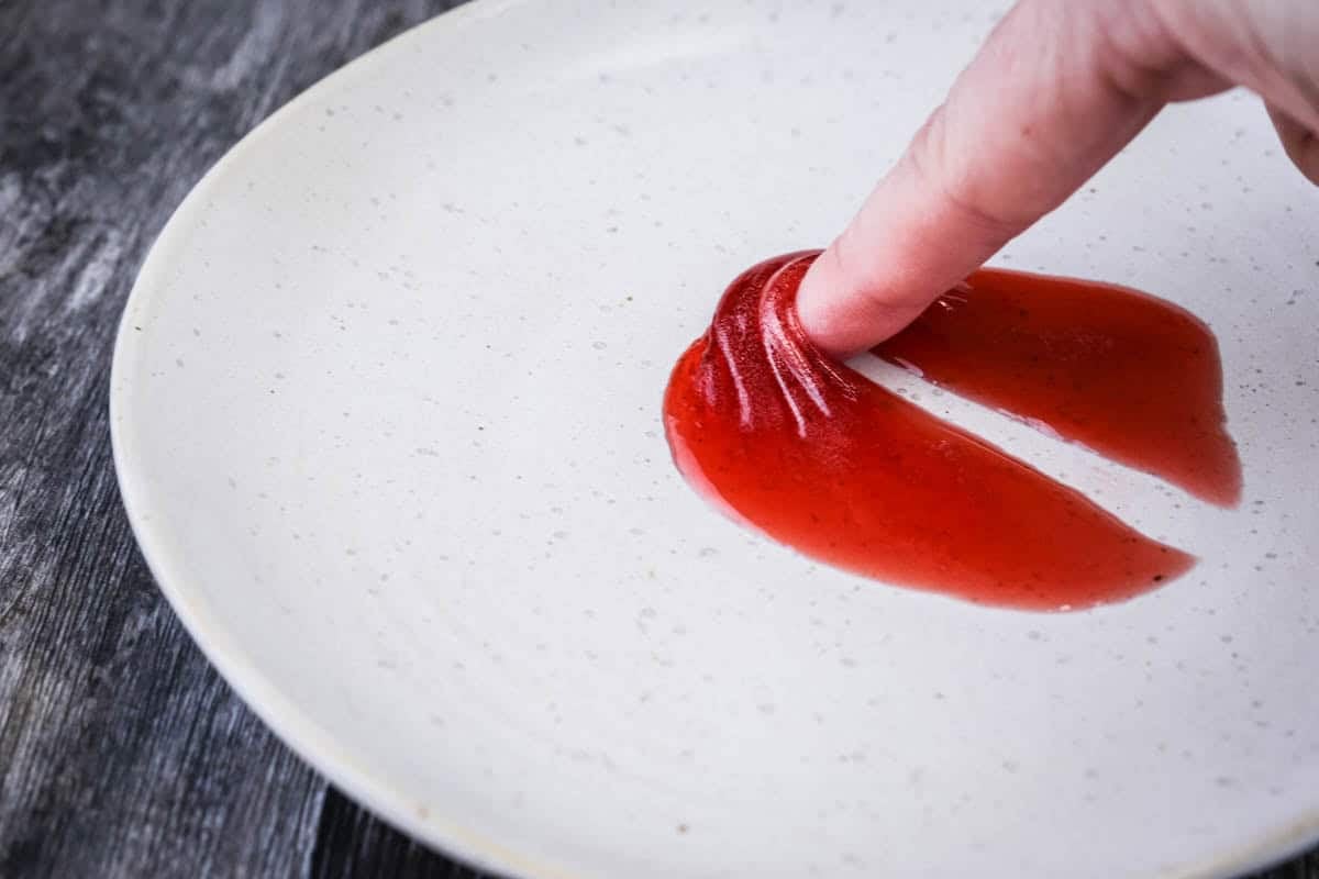 Finger is pushing into jam and it is wrinkling firmly and the jam is pretty solid showing the jam is overset.