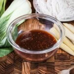 Gluten Free Stir Fry Sauce in a small bowl surrounded by stir fry vegetables.