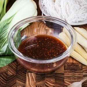 Gluten Free Stir Fry Sauce in a small bowl surrounded by stir fry vegetables.