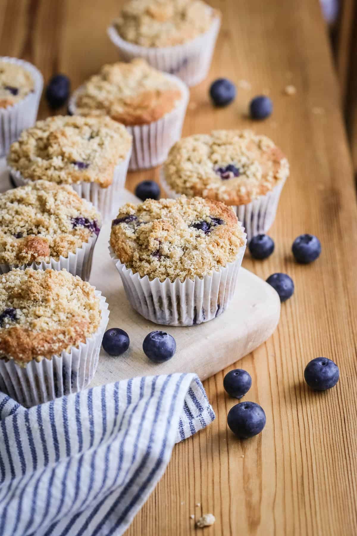 Blueberry Muffins on a table showing golden crumb upon baking.