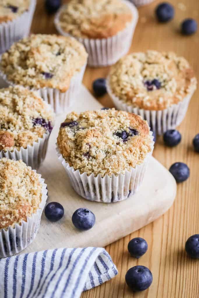 Blueberry Muffins on a table showing golden crumb upon baking.