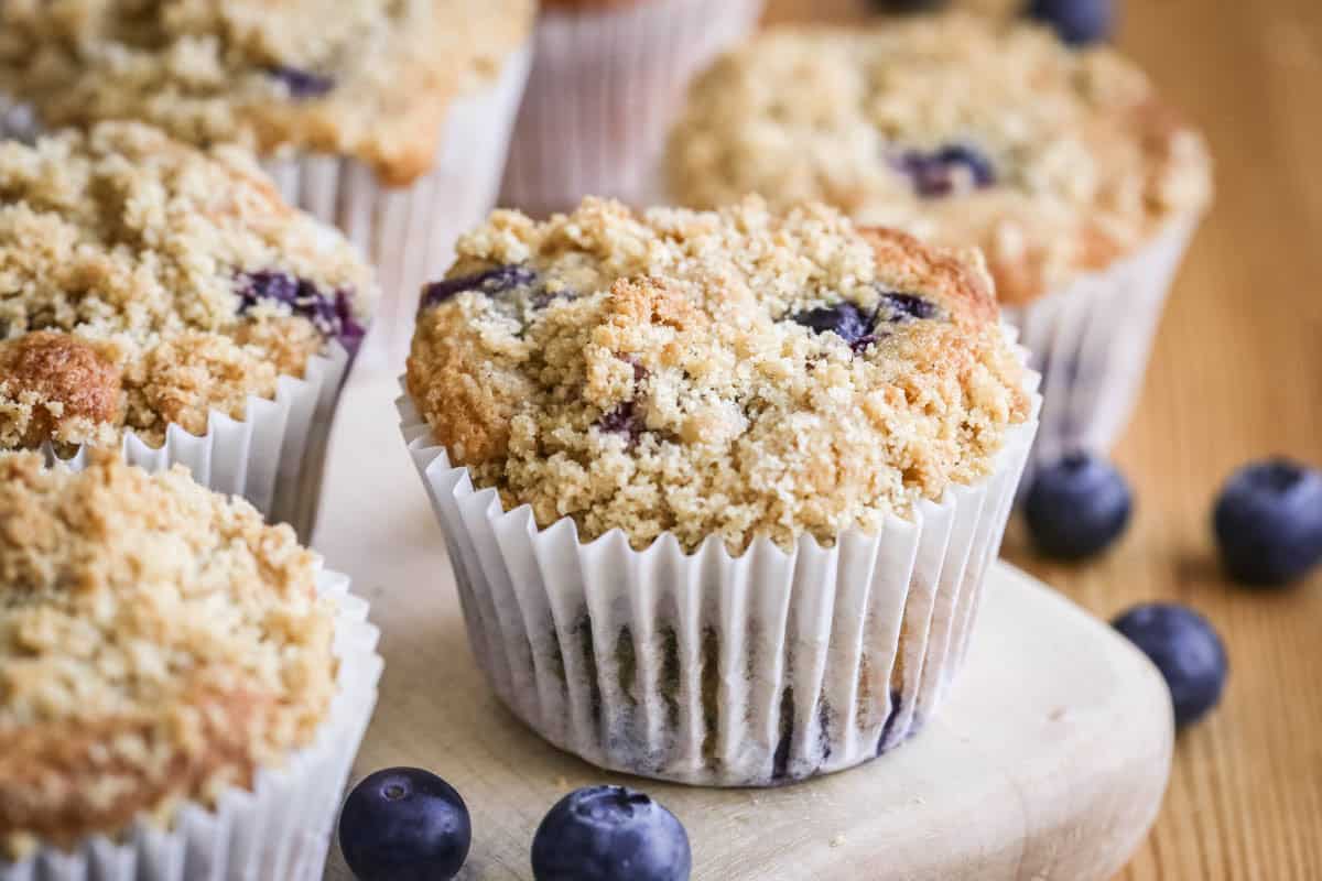 Blueberry Muffin on a table showing golden crumb upon baking.