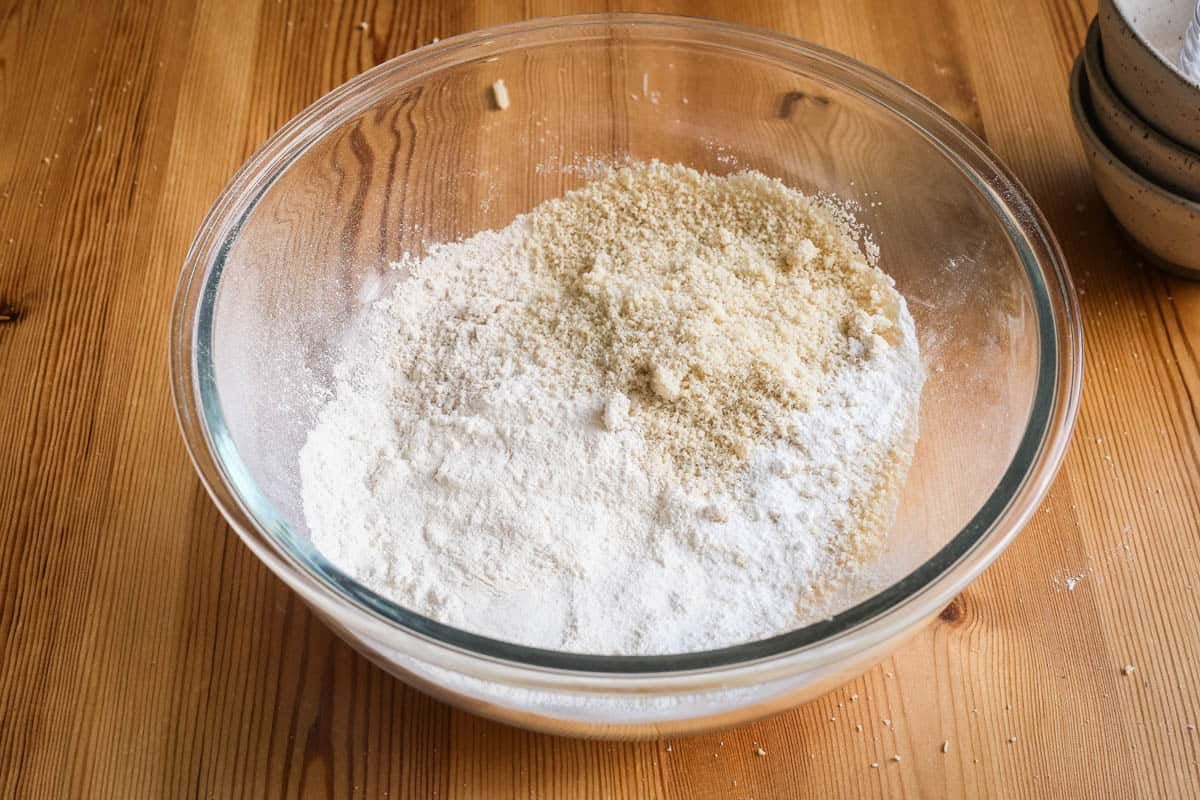 Dry ingredients for blueberry muffins ready to be whisked together in a bowl.