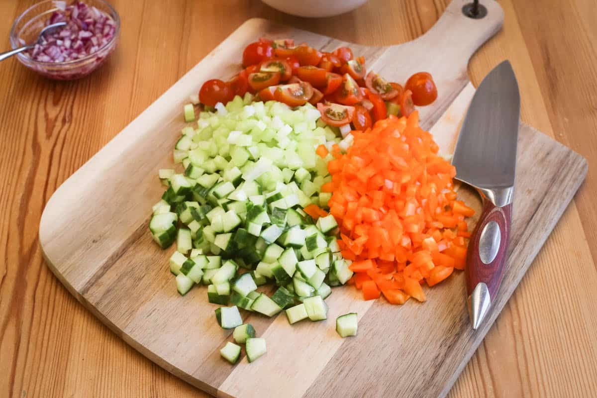 Salad vegetables cut into uniform pieces.