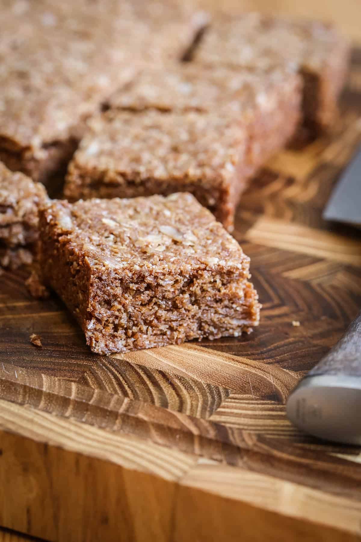 Square of Gluten Free Flapjack on a wooden board.