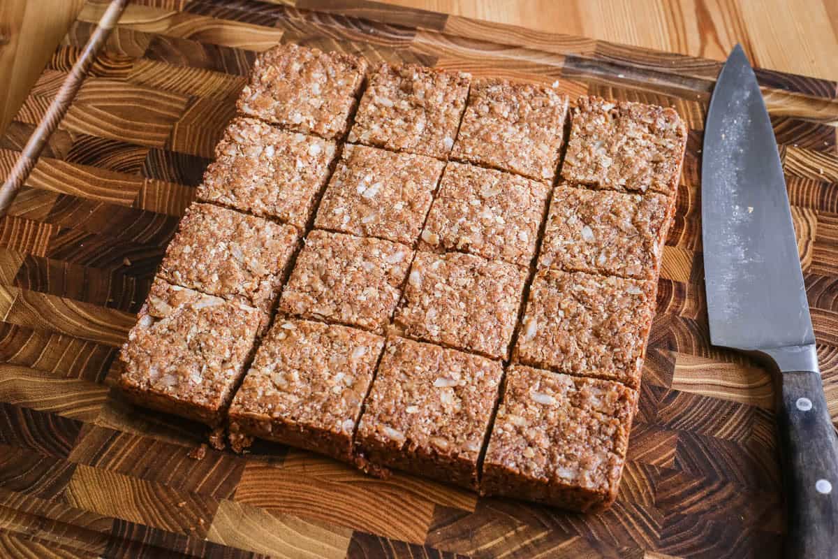 Flapjacks cut into perfect squares on wooden board.