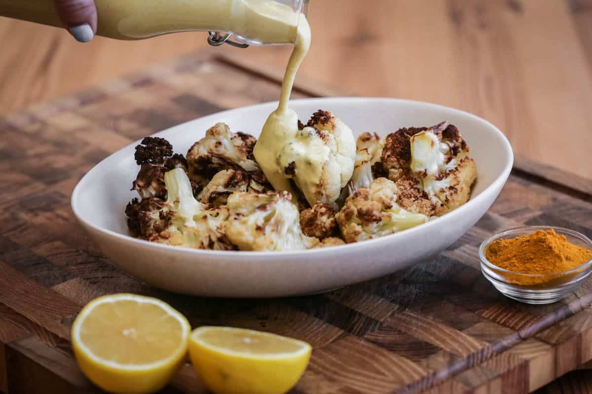 Tahini Dressing poured over roasted cauliflower.