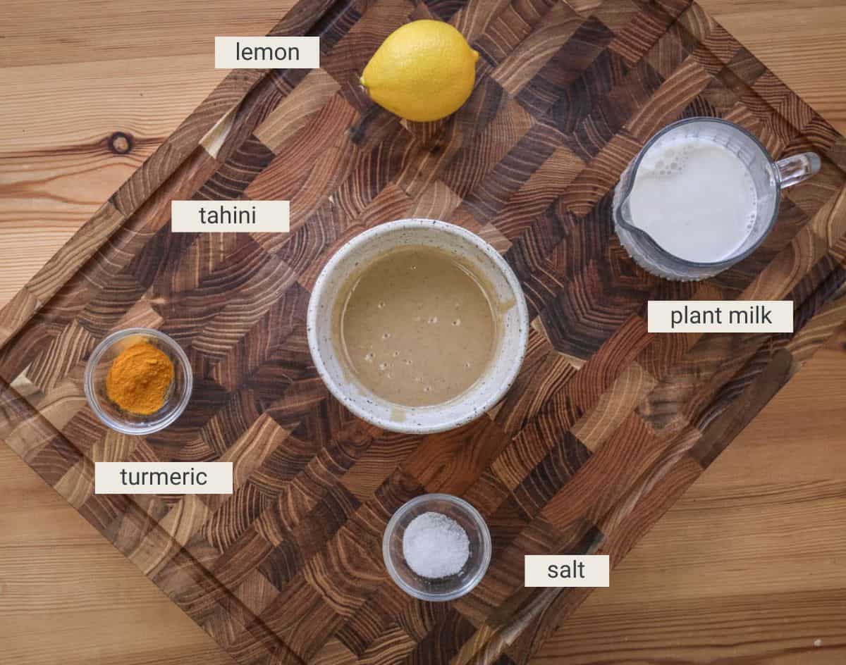 Tahini dressing ingredients on a board.