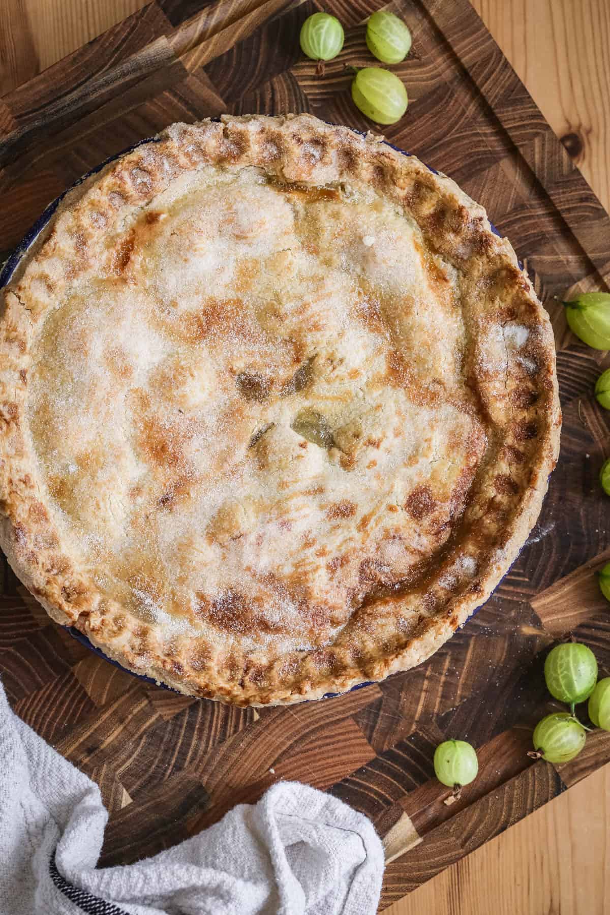 A freshly baked gooseberry pie showing crisp golden crust.