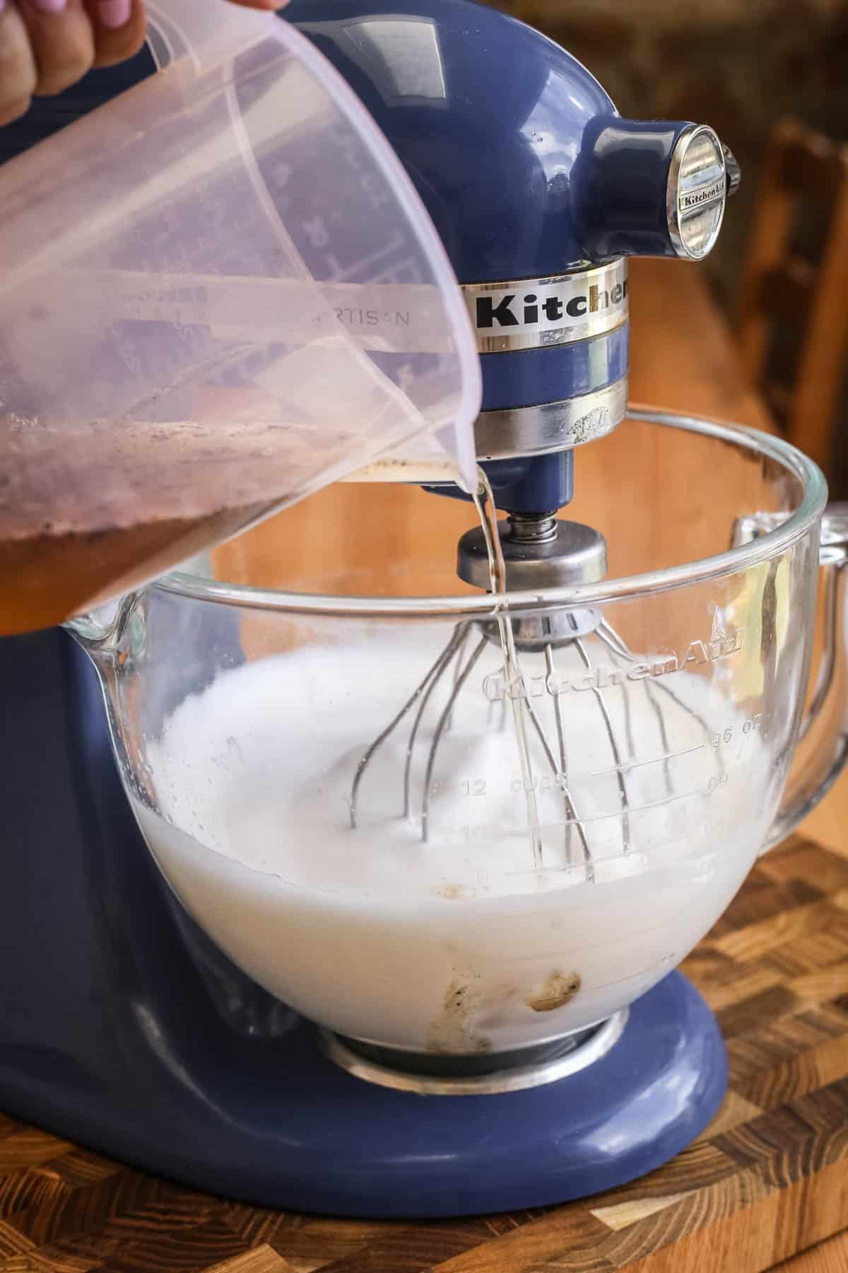 Sugar syrup poured slowly into whipped aquafaba in stand mixer.