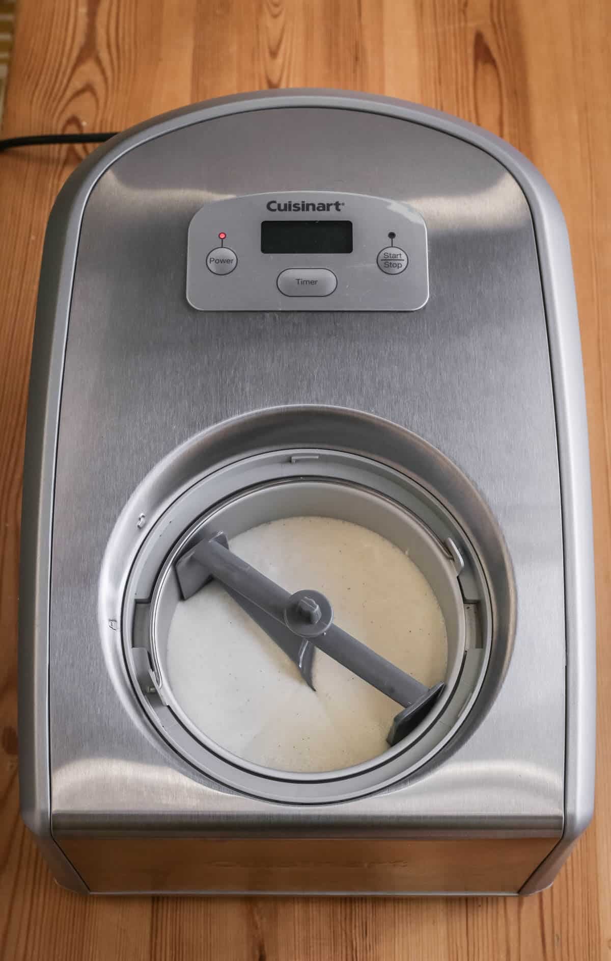 Vegan Vanilla Ice Cream mixture poured into ice cream machine ready for churning.