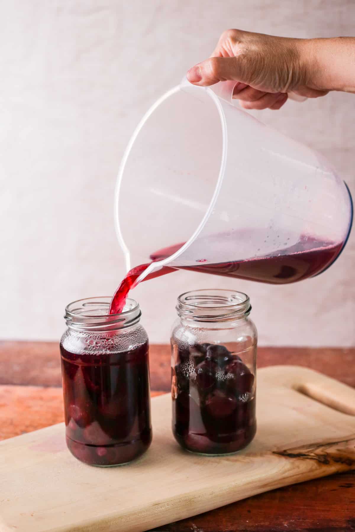 Kirsch cherry syrup poured over the cherries in the sterilised jars.