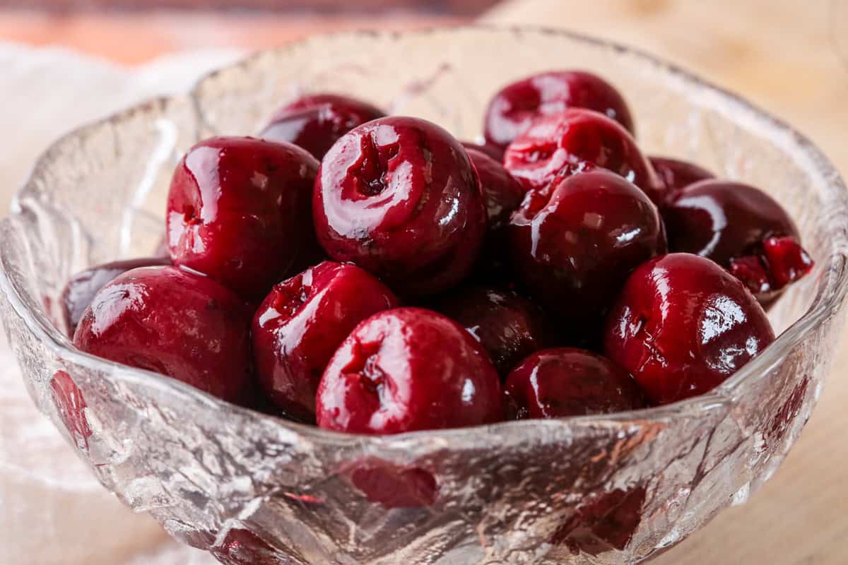 Kirsch Cherries drained in a glass bowl.