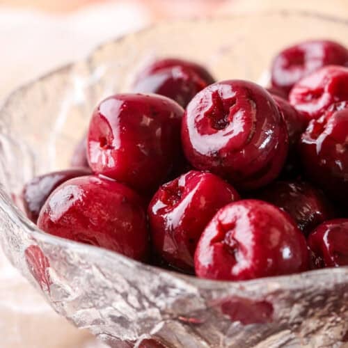 Kirsch Cherries drained in a glass bowl.