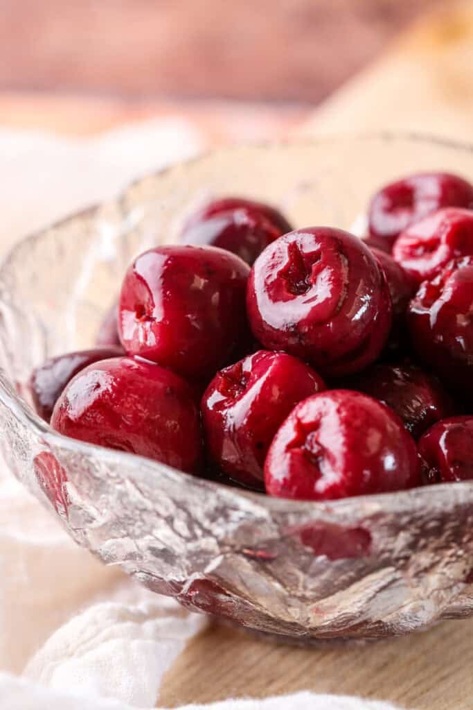 Kirsch Cherries drained in a glass bowl.