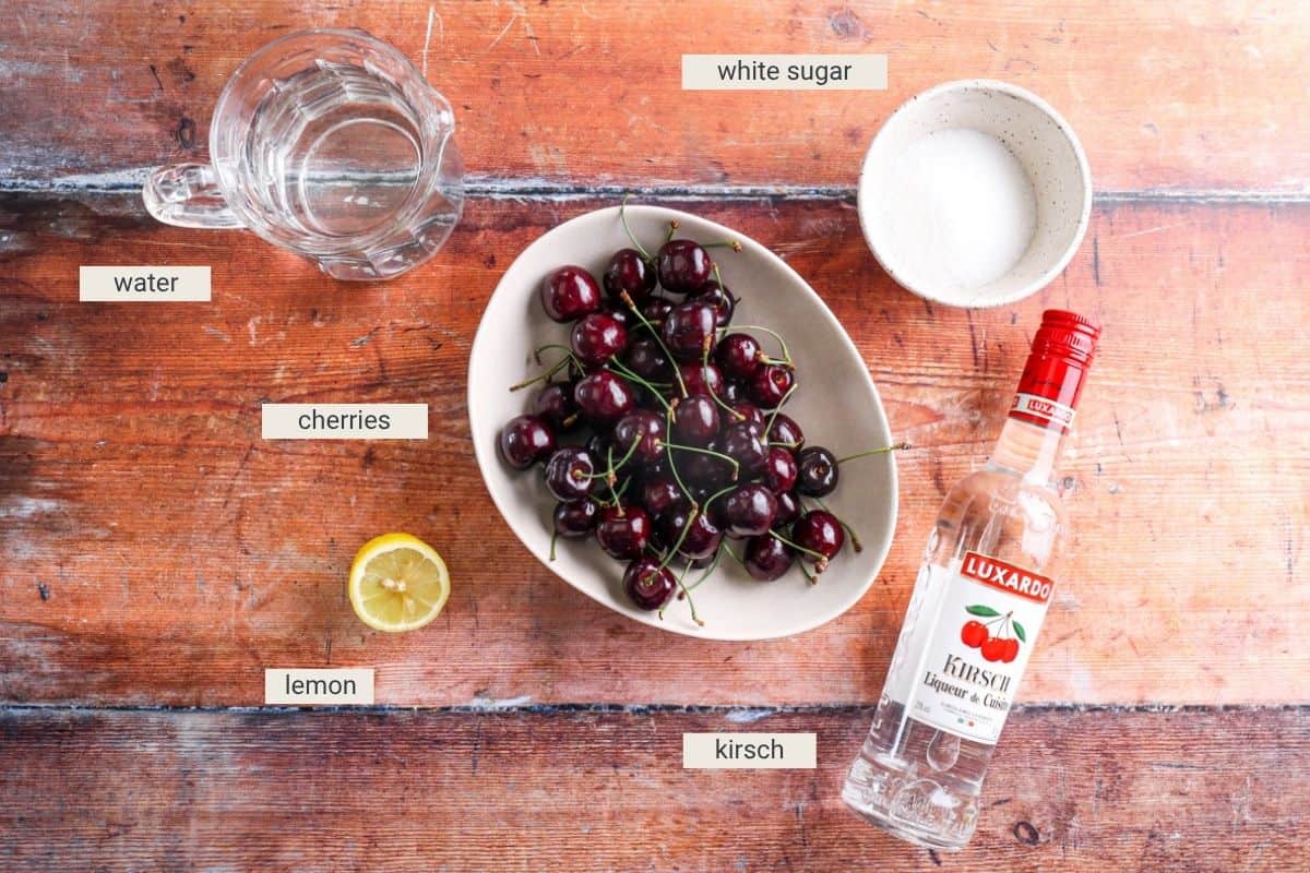 Cherries in Kirsch ingredients on table.
