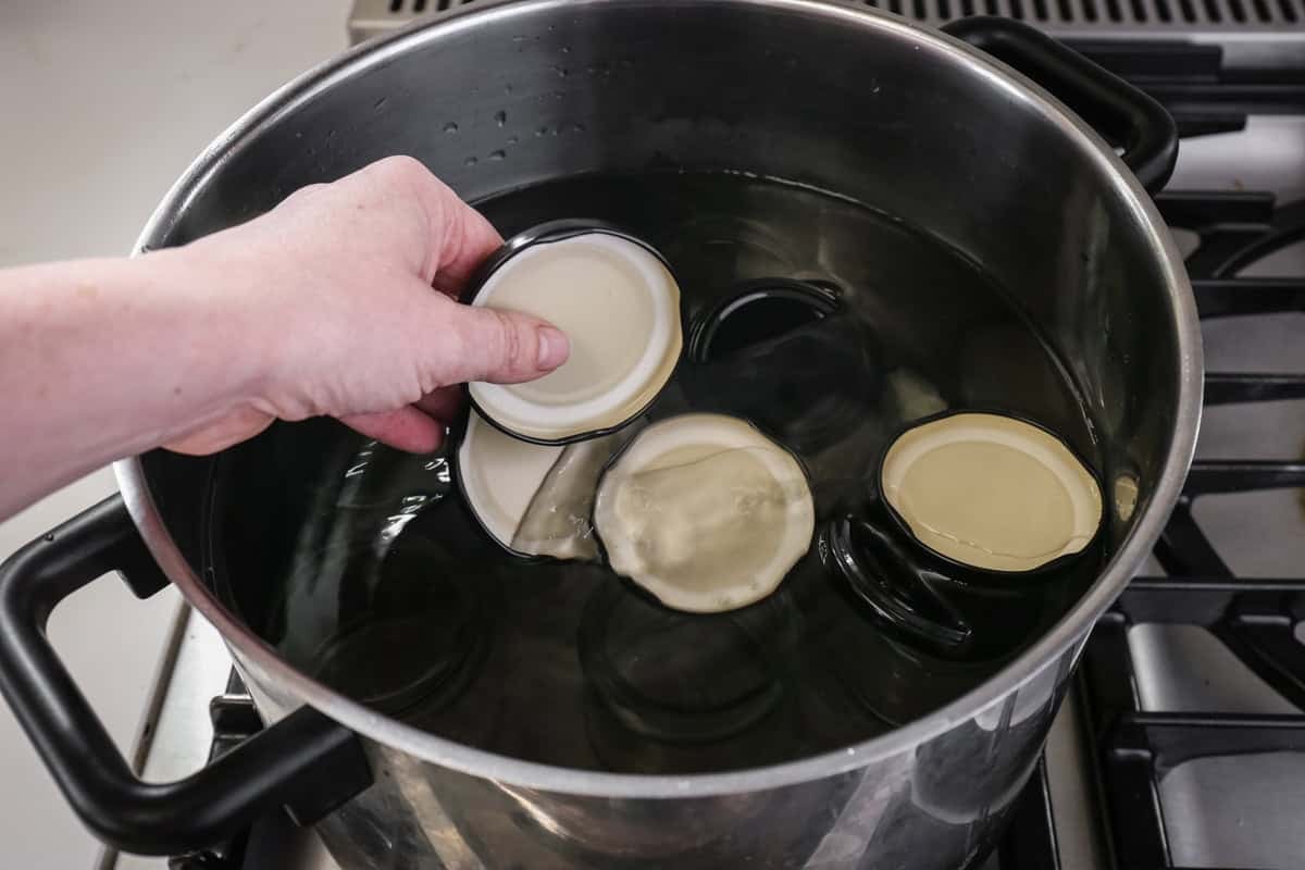 Lids begin placed in a pot full of water for sterilisation.