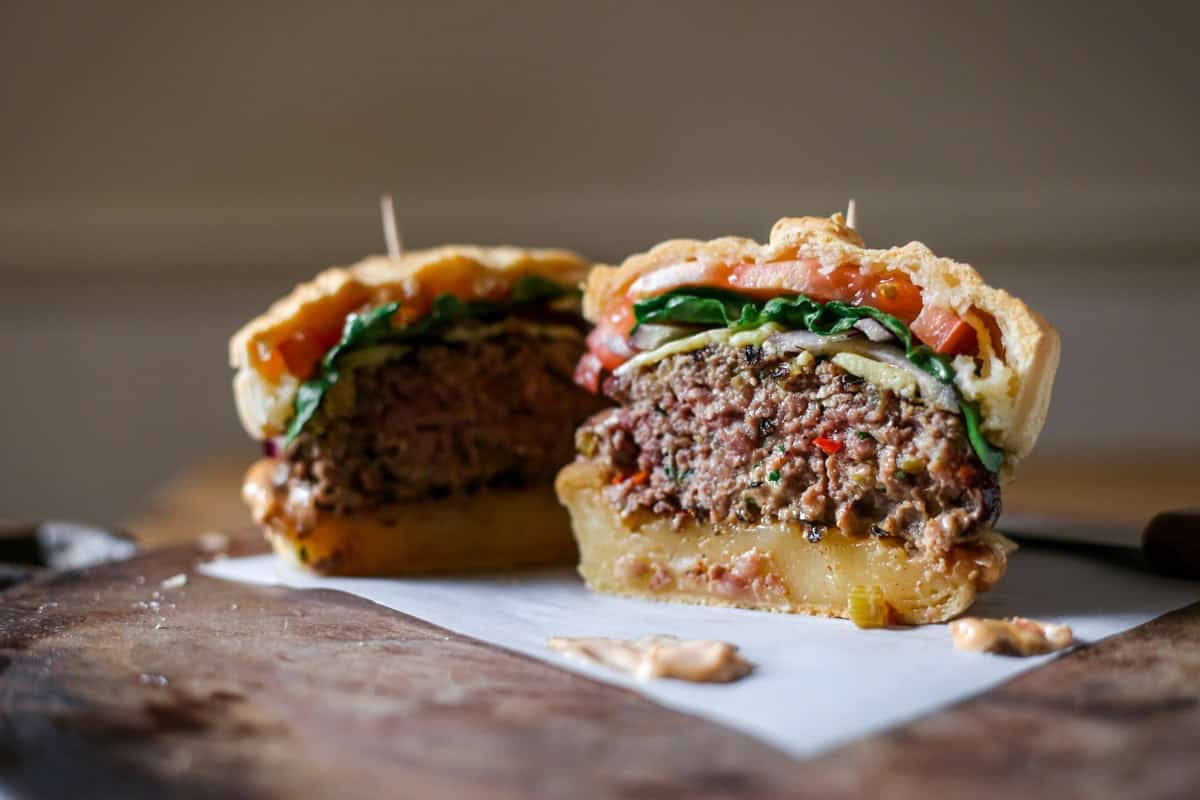 Burger cut in half showing very juicy inside.